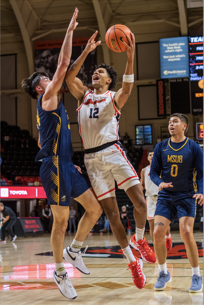 Forward Michael Rataj goes up for a basket against the Montana State Billings Yellow Jackets on October 26.